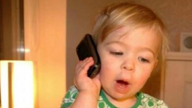 Photo of A Child Dials 911 Seeking Assistance From Police Officer