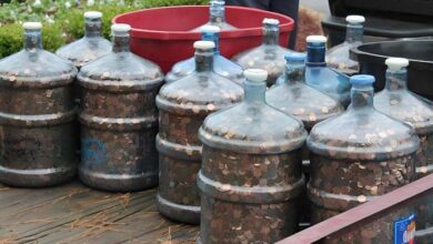 Photo of Man saves coins for 45 years, rolls 15 water jugs into bank and tells teller to deposit ’em all.